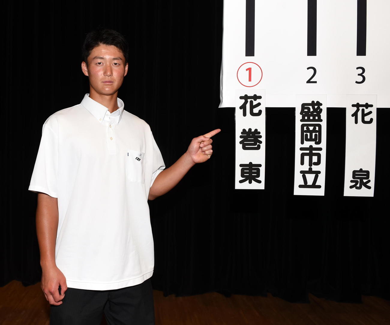 トーナメント表の前で花巻東の札を指さす千葉主将