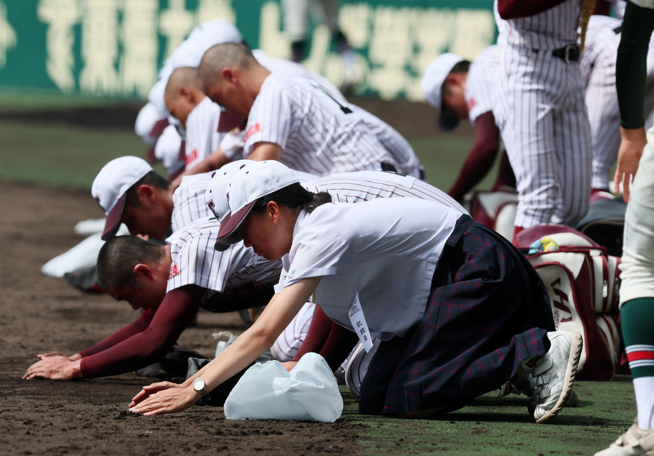 日大三に敗れ、甲子園の土をナインと一緒に集める鳥栖工の女子マネジャー緒方美月さん（撮影・加藤哉）