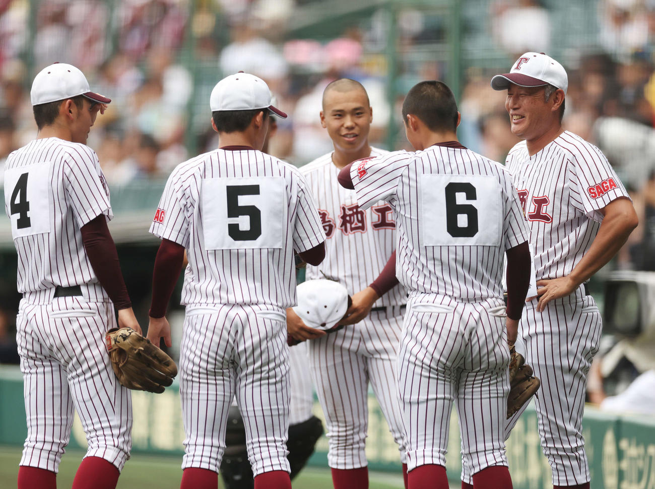 鳥栖工対日大三　笑顔で選手たちに声をかける鳥栖工・大坪監督（右）（撮影・宮地輝）