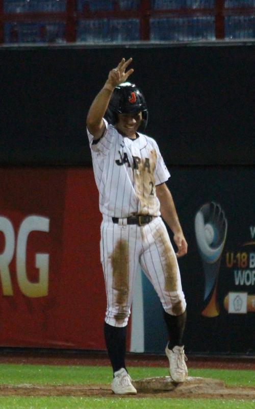 パナマ対日本　2回裏日本2死、二塁への当たりが内野安打となり、慶応の選手たちがやっていた3本指ポーズを決める緒方（撮影・保坂恭子）