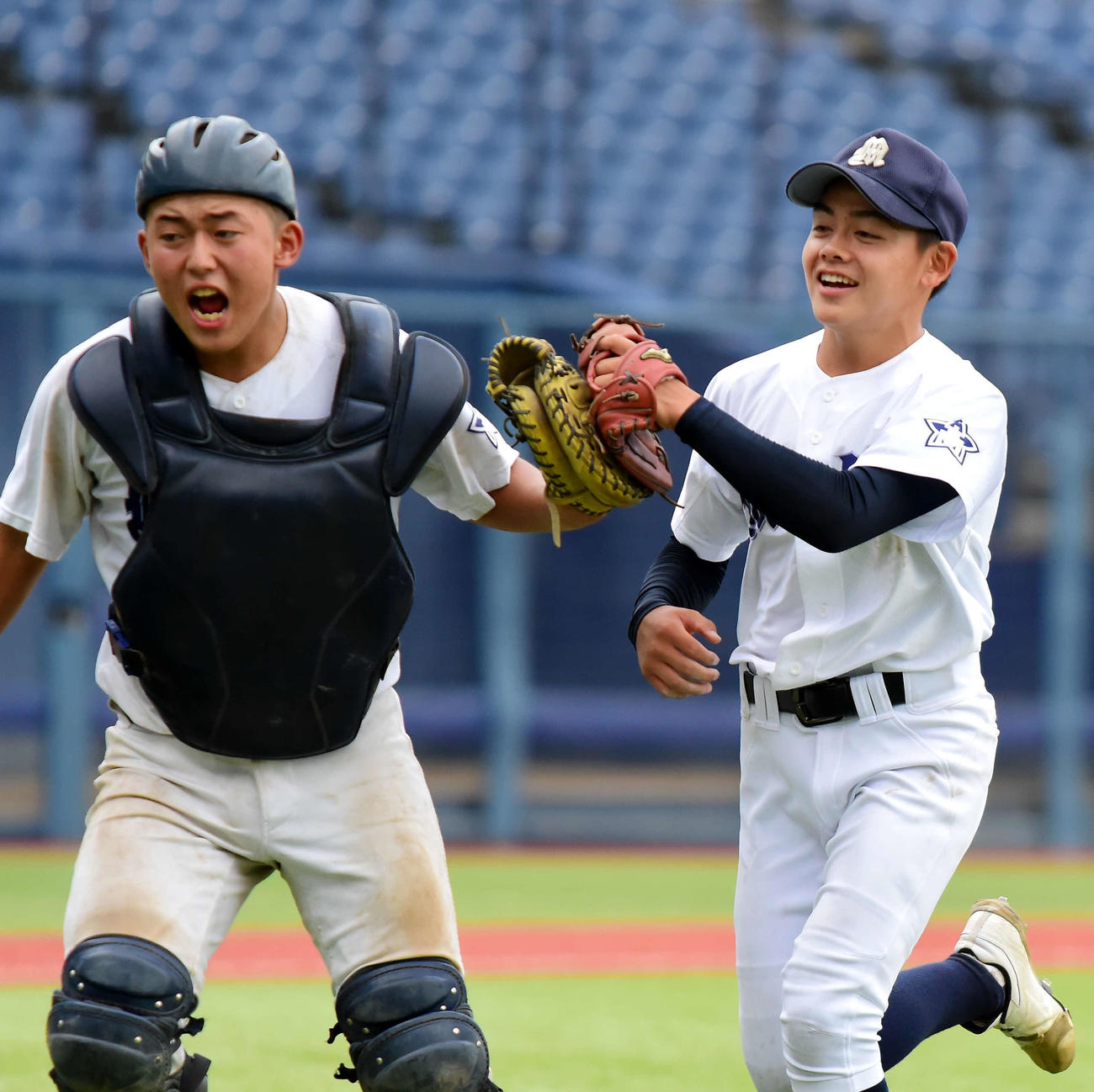 7回のピンチをしのぎ、ハイタッチする巻の先発・保倉（右）と田辺