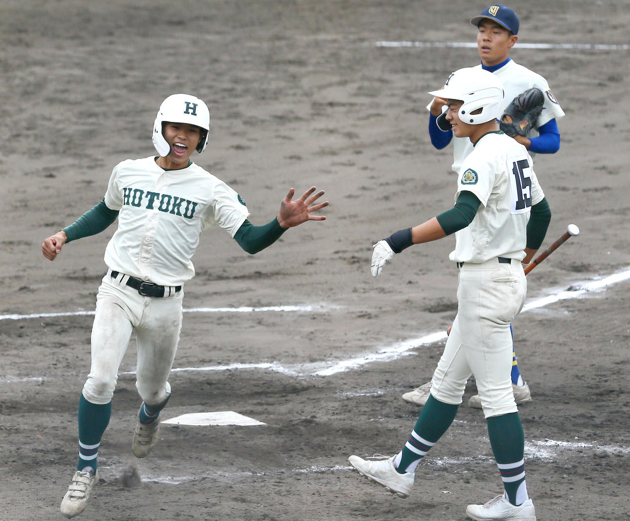 報徳学園対奈良大付　5回裏報徳学園2死一、三塁、三走橋本（左）は暴投で生還し喜ぶ。右上は投手杉山、右は次打者の辻本（撮影・上山淳一）