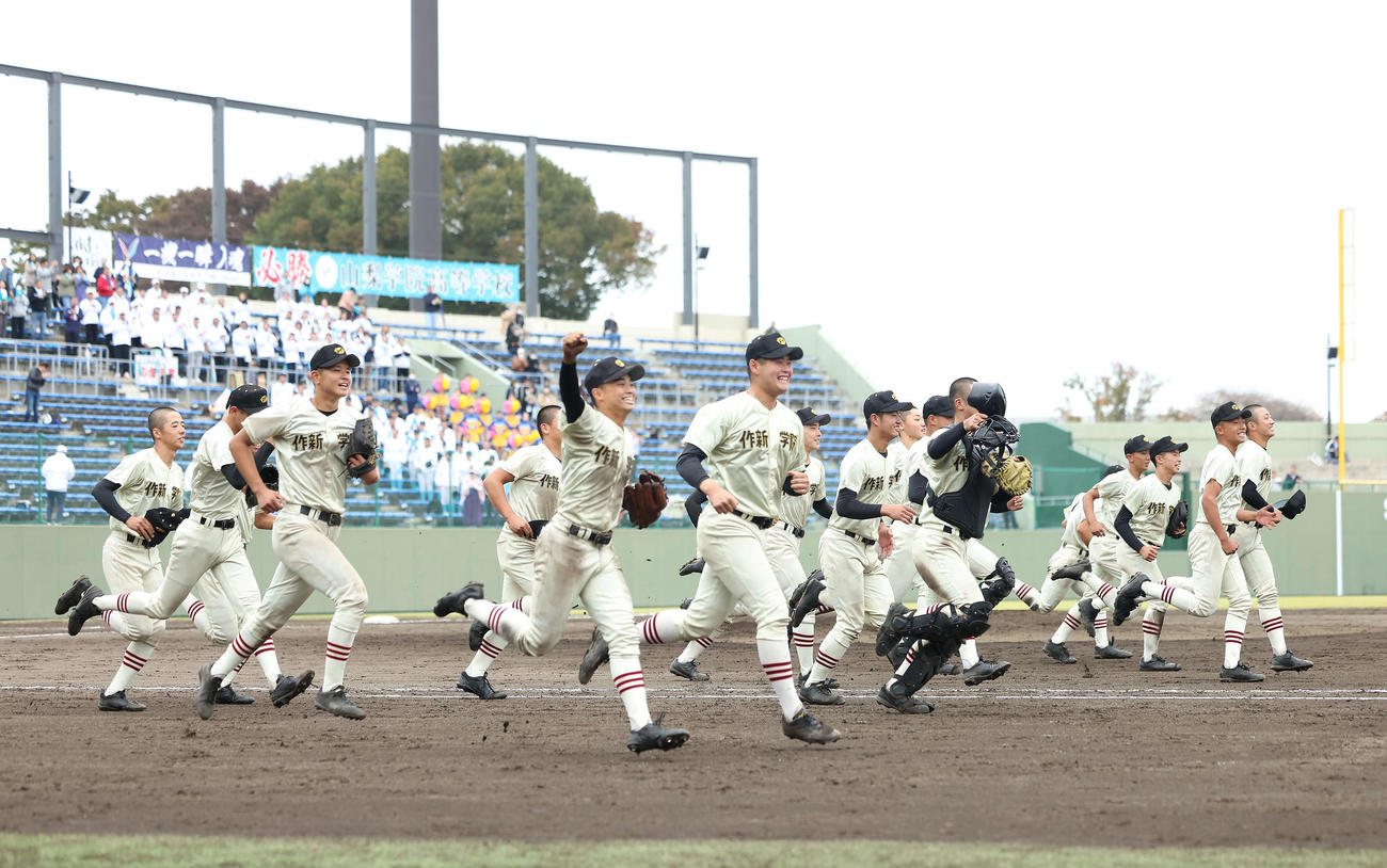 優勝を決め、笑顔でスタンドに向かう作新学院ナイン（撮影・河田真司）