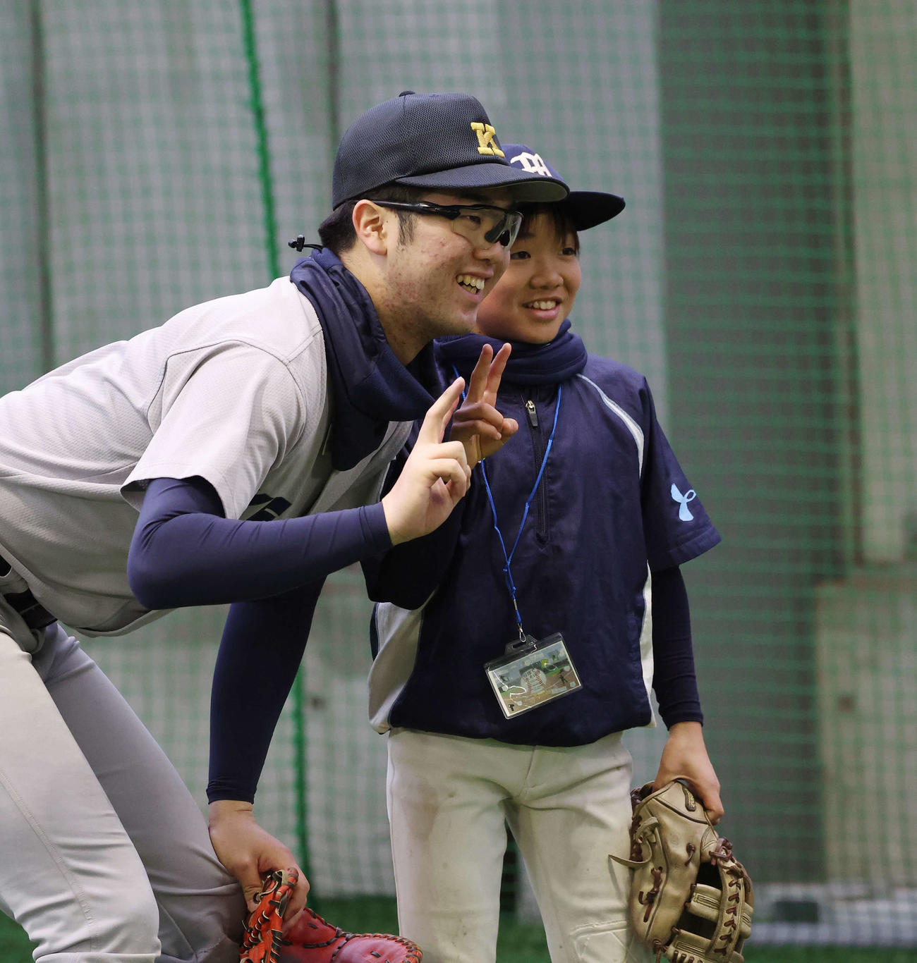 「野球で遊ぼう2024」で子どもと笑顔でピースをする慶応・延末（撮影・宮地輝）
