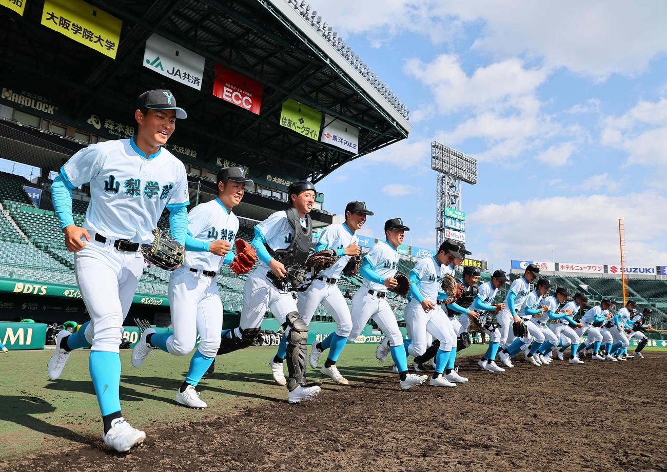グラウンドに元気よく飛び出す山梨学院の選手たち（撮影・上田博志）
