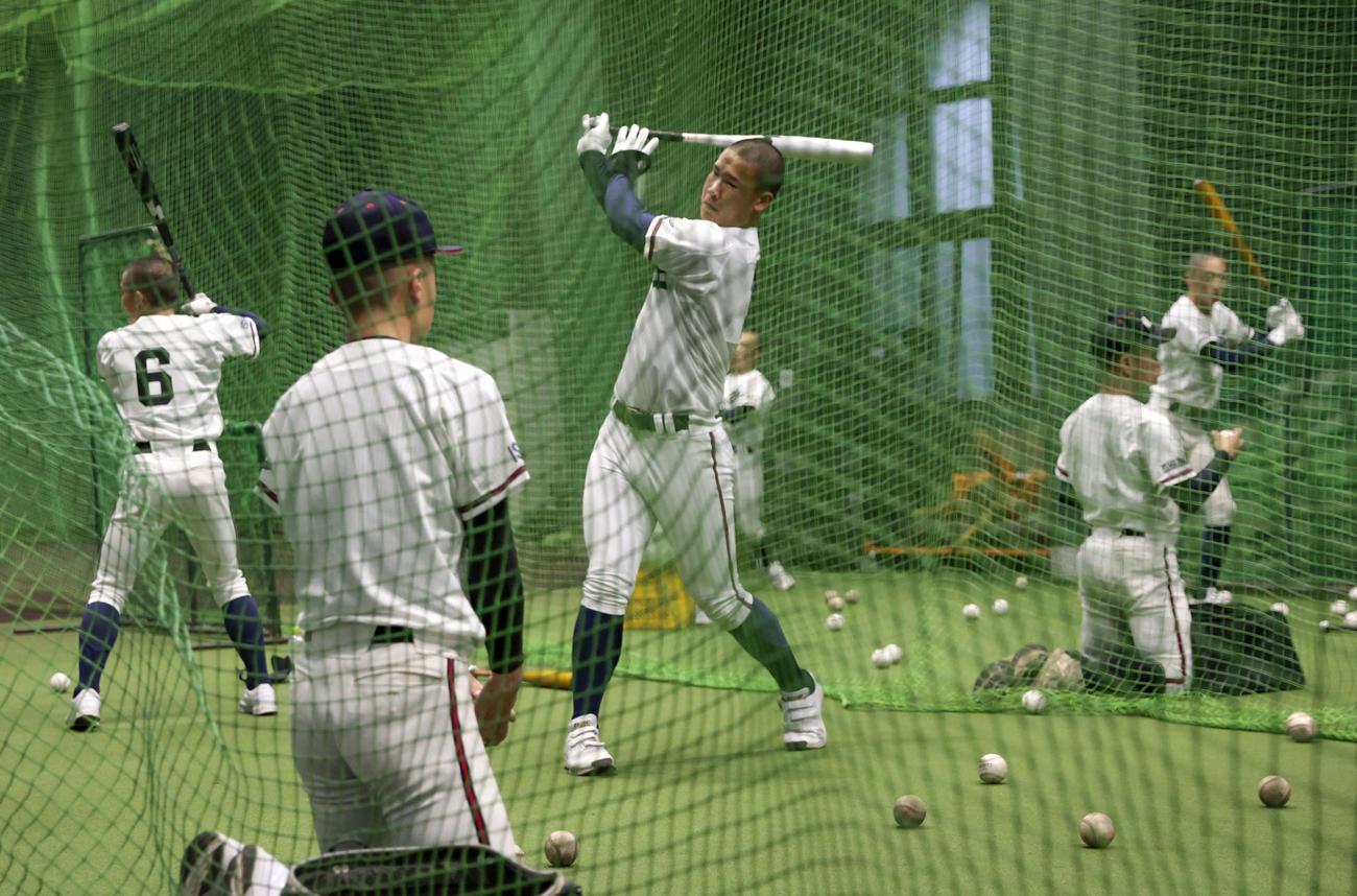 天候不良で試合が順延となり、室内練習場で調整する日本航空石川の選手たち（共同）