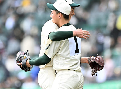 中央学院対報徳学園 試合後、報徳学園先発の間木(右)は、2番手で試合を締めた今朝丸とハグする(撮影・滝沢徹郎)