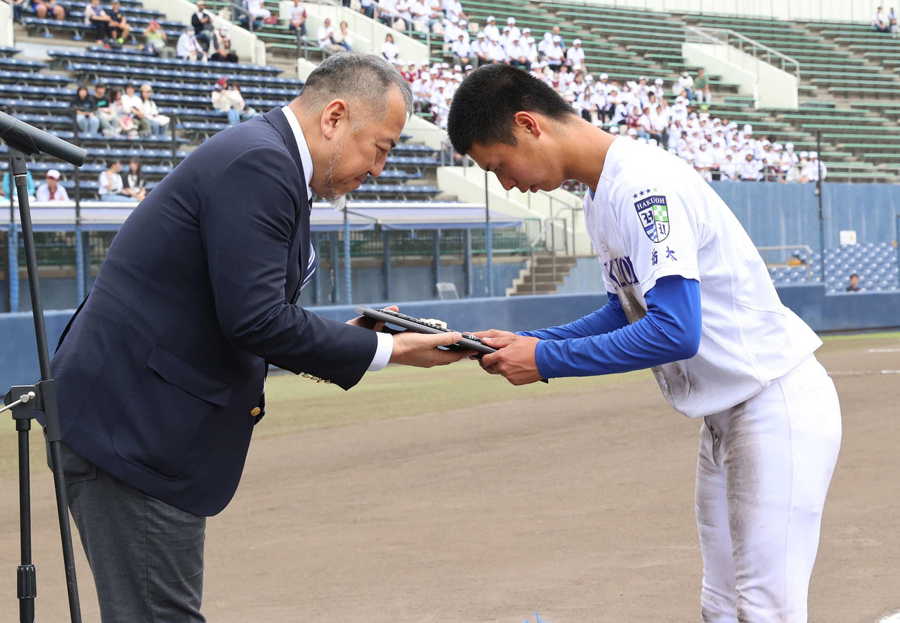 優勝した白鴎大足利の杉山（右）に盾を手渡す日刊スポーツ鈴木野球部長（撮影・河野匠）