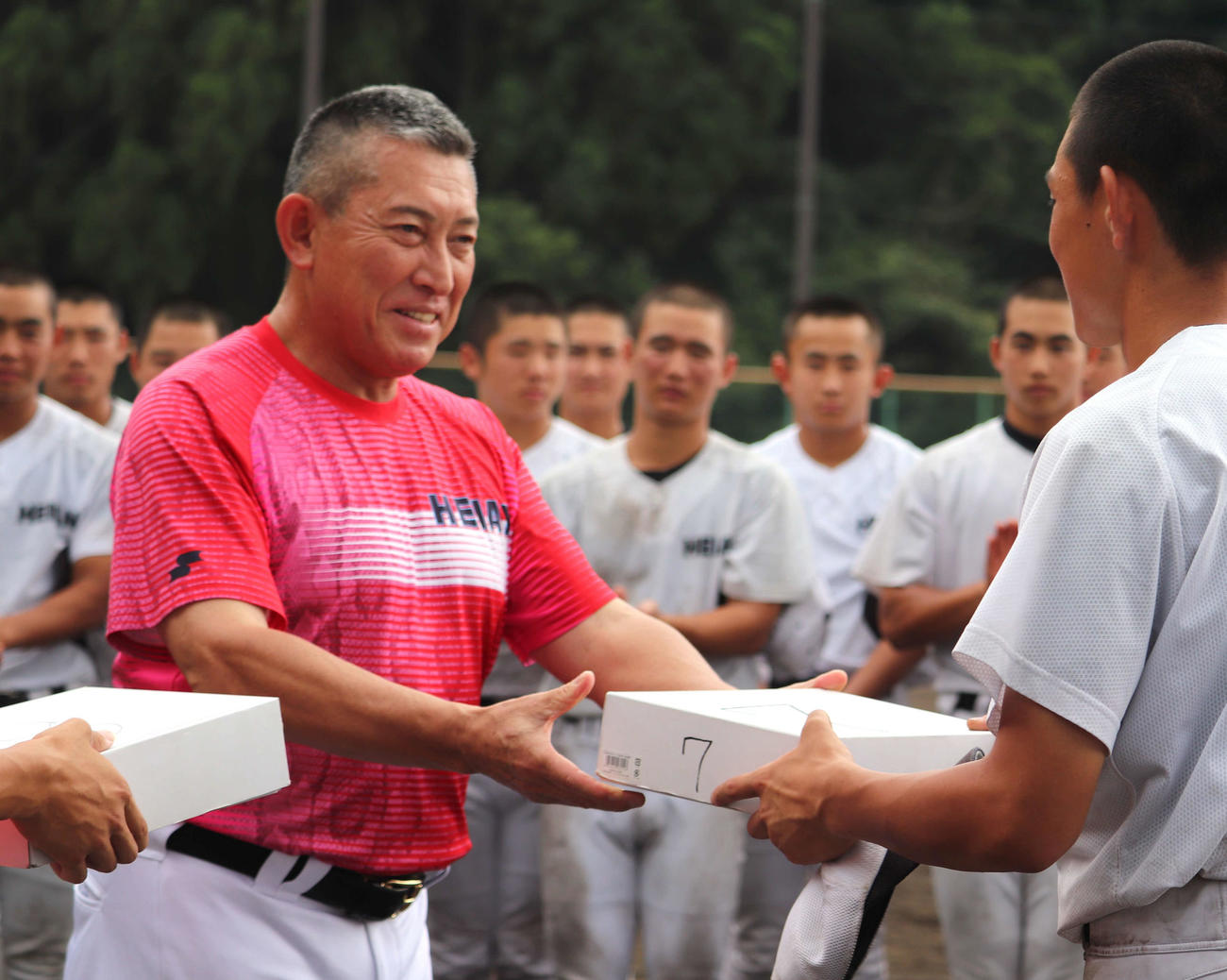 京都大会にメンバー入りした選手へユニホームを手渡す、龍谷大平安（京都）の原田英彦監督（撮影・中島麗）