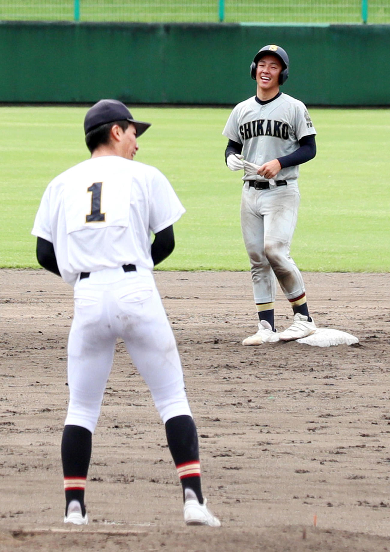神戸弘陵対飾磨工　9回裏飾磨工1死、本庄は村上（手前）から中越え二塁打を放ち二塁で笑顔を見せる（撮影・上山淳一）