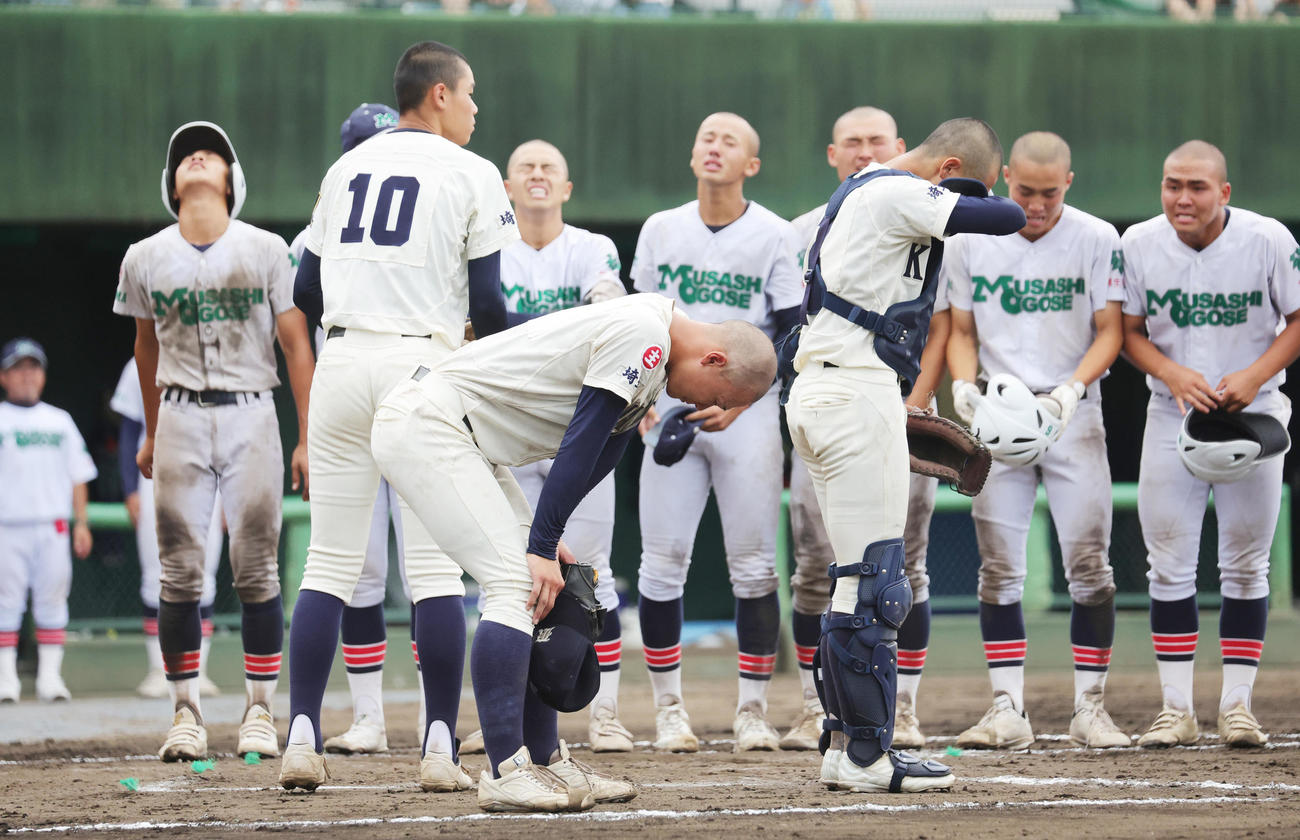 タイブレークの10回裏、サヨナラ勝ちし喜ぶ武蔵越生の選手たちと、がっくりの熊谷商・中村謙（手前）（撮影・野上伸悟）