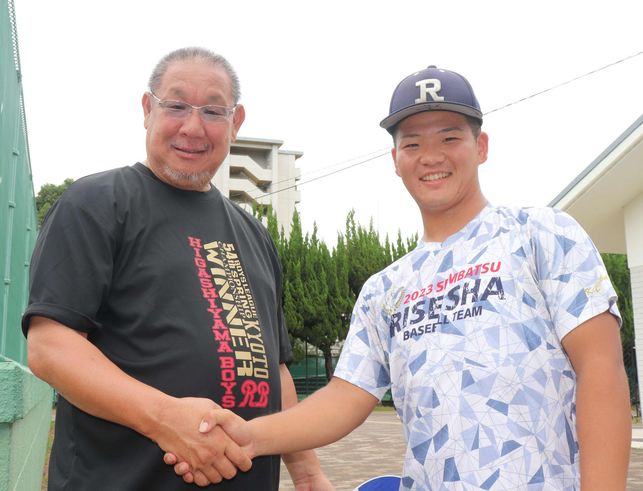 大阪大会豊中対履正社　試合後、中学時代の古巣・京都東山ボーイズ・レッドベアーズの甲斐省三監督（55）と写真に収まる履正社の近沢（撮影・中島麗）