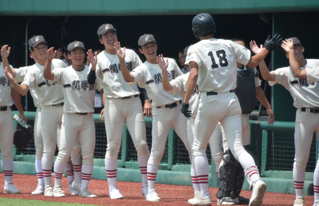 一関学院対福岡　7回2死、代打出場し、右越えソロ本塁打を放ち、チームメートに笑顔で迎えられる一関学院・登嶋（背番号18）（撮影・濱本神威）