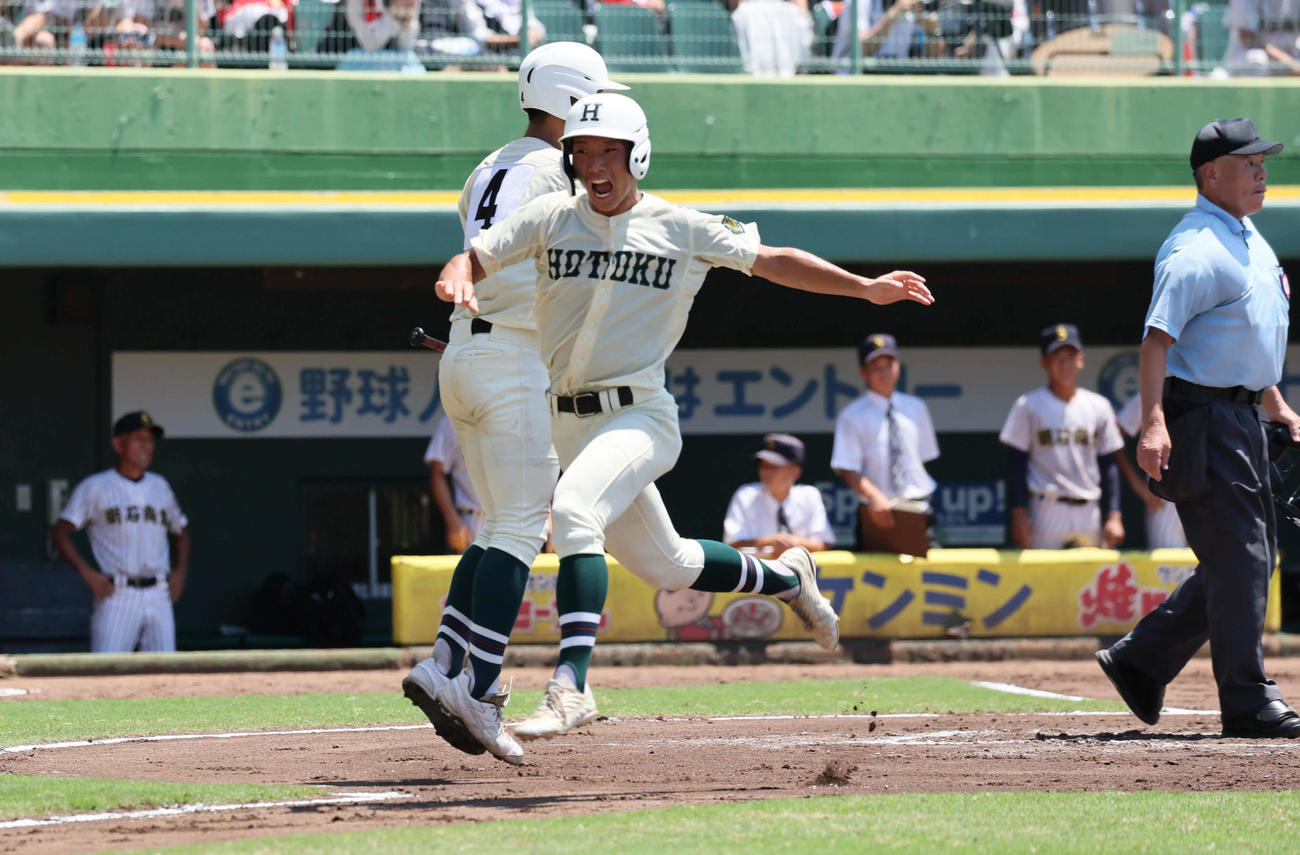 明石商対報徳学園　6回裏報徳学園1死2塁、安井（右）は橋本の右前先制適時打で生還する（撮影・宮崎幸一）