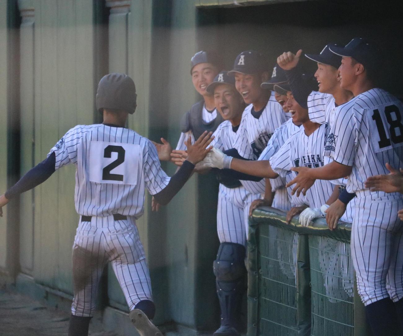 5回、阿南光の井坂琉星捕手が先制のホームを踏んでベンチでタッチを交わす（撮影・林亮佑）