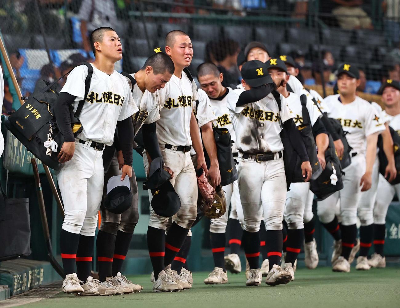 札幌日大対京都国際　京都国際に敗れた札幌日大エース小熊（左）は甲子園のグラウンドを見渡しながら引き揚げる（撮影・上田博志）