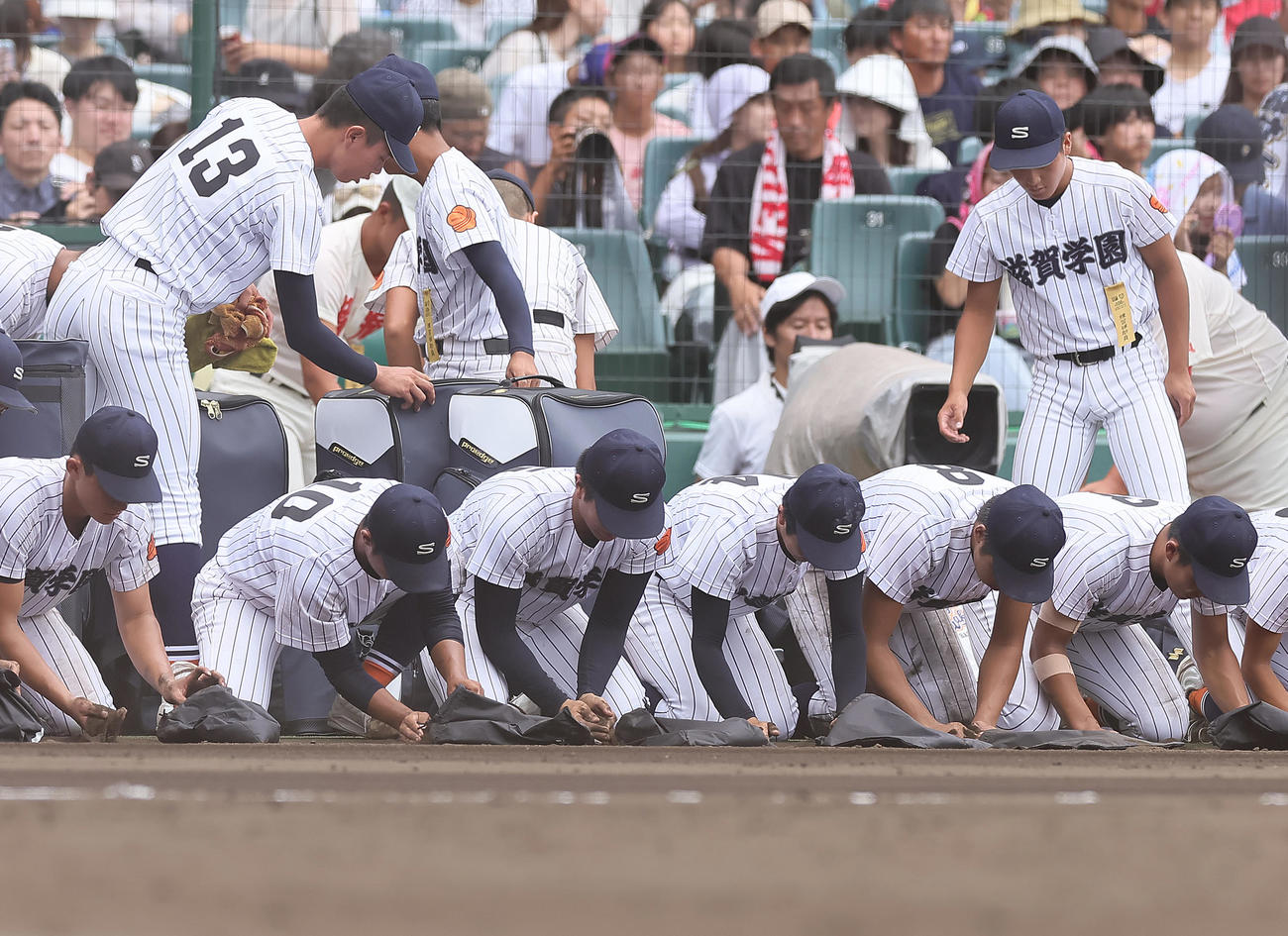 滋賀学園対青森山田　青森山田に敗れ、甲子園の土を拾う滋賀学園（撮影・足立雅史）