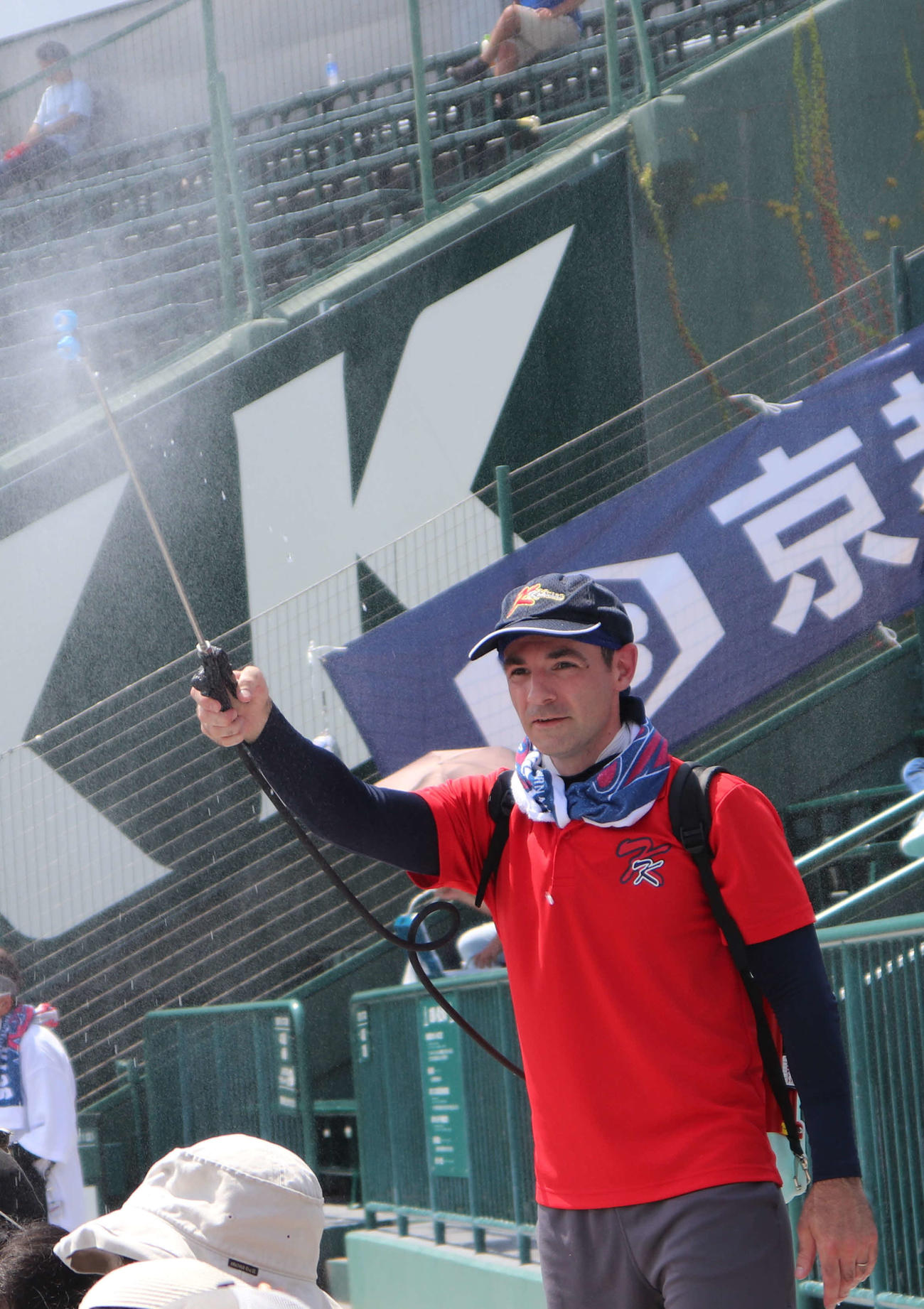 京都国際のスタンドをミストシャワーで涼しくした、同校の英語教師リード・フィリップ先生（撮影・中島麗）