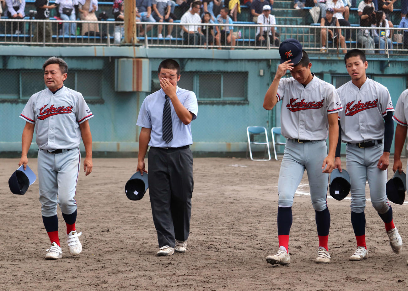 京都外大西との4回戦　延長11回タイブレークの末に敗れ、ベンチへ帰る京都国際・小牧監督（写真左）と岩田陽希記録員、西村ら（撮影・中島麗）