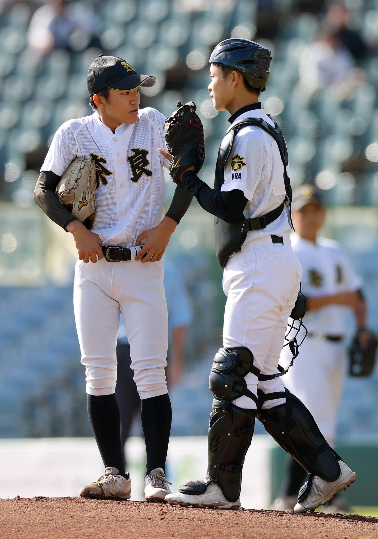奈良対立命館宇治　1回裏、マウンドで話し合う奈良のエース神山（左）と捕手西口（撮影・上山淳一）
