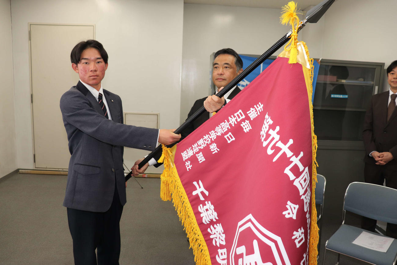 センバツ旗授与式で、千葉黎明の吉田英雄校長（右）からセンバツ旗を受け取る山本主将（撮影・保坂淑子）