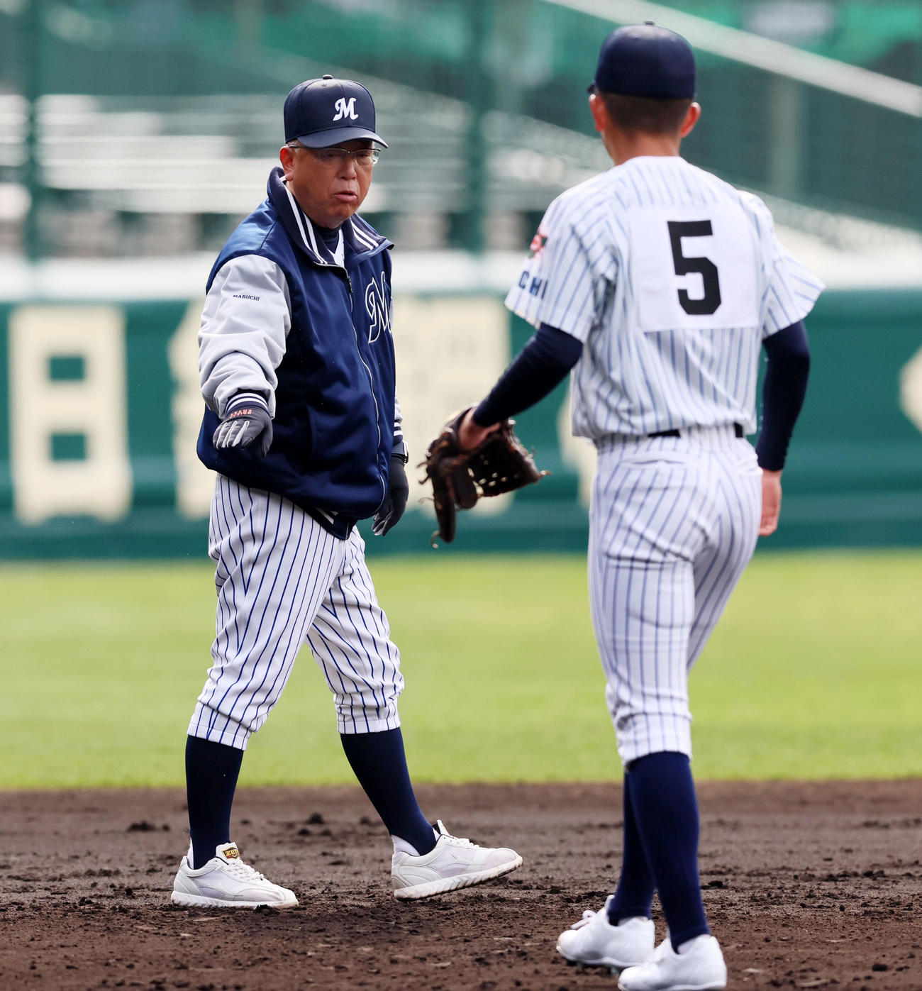 グラウンドを歩いてナインにアドバイスを送る明徳義塾の馬淵監督（撮影・加藤哉）