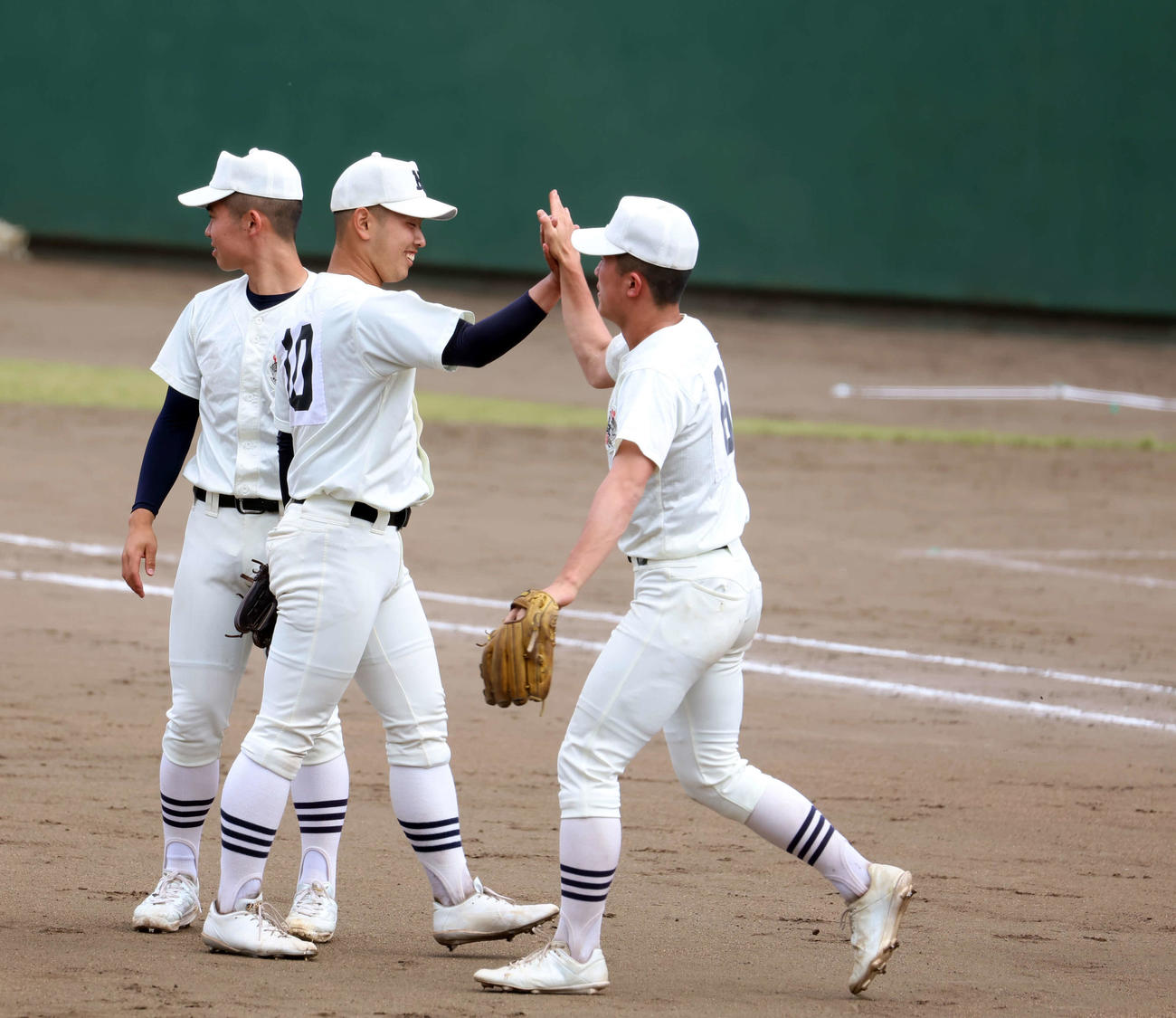 高校野球春季東京都大会準々決勝　早実対日大三　日大三の先発近藤（左から2人目）は9回1失点と好投し、仲間とハイタッチを行った（撮影・山本朝陽）