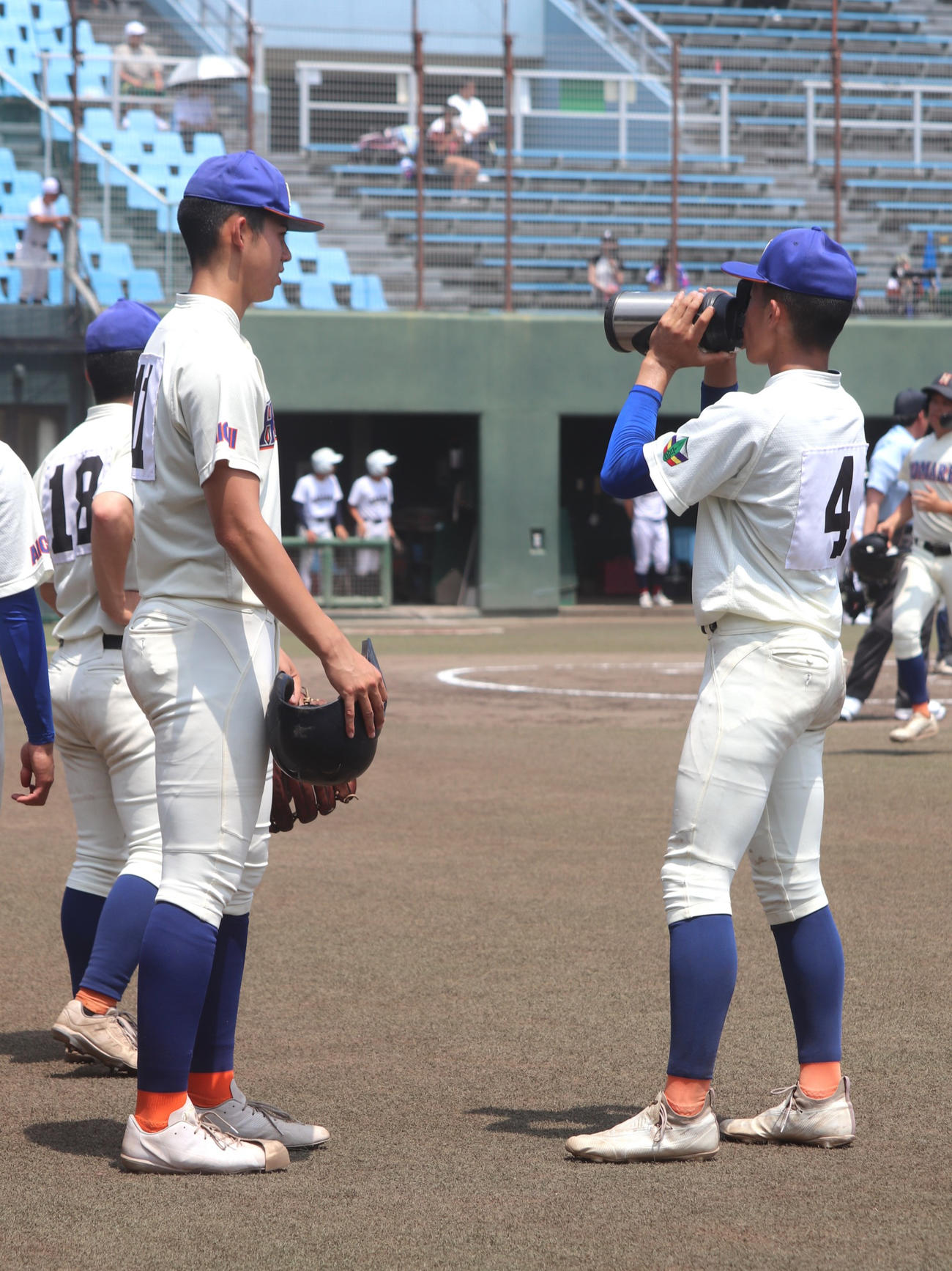 愛知大会2回戦　愛知総合工科対誉　4回の攻撃前に誉の原口に水筒を差し出す、背番号11のモレチ（撮影・中島麗）