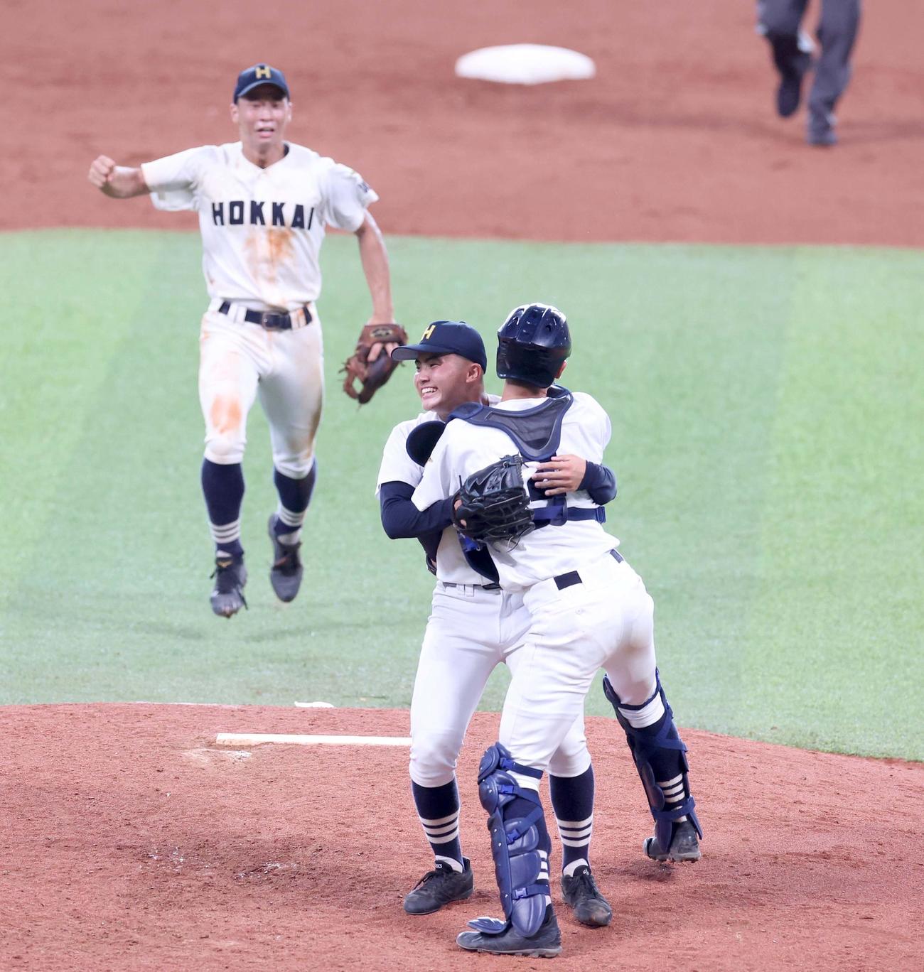 札幌日大対北海　優勝し笑顔で長南と抱き合う北海・浅水（中央）（撮影・黒川智章）