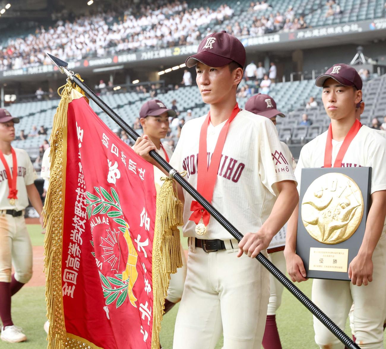 白樺学園対旭川志峯　優勝旗持ち行進する旭川志峯の稲葉主将（撮影・黒川智章）