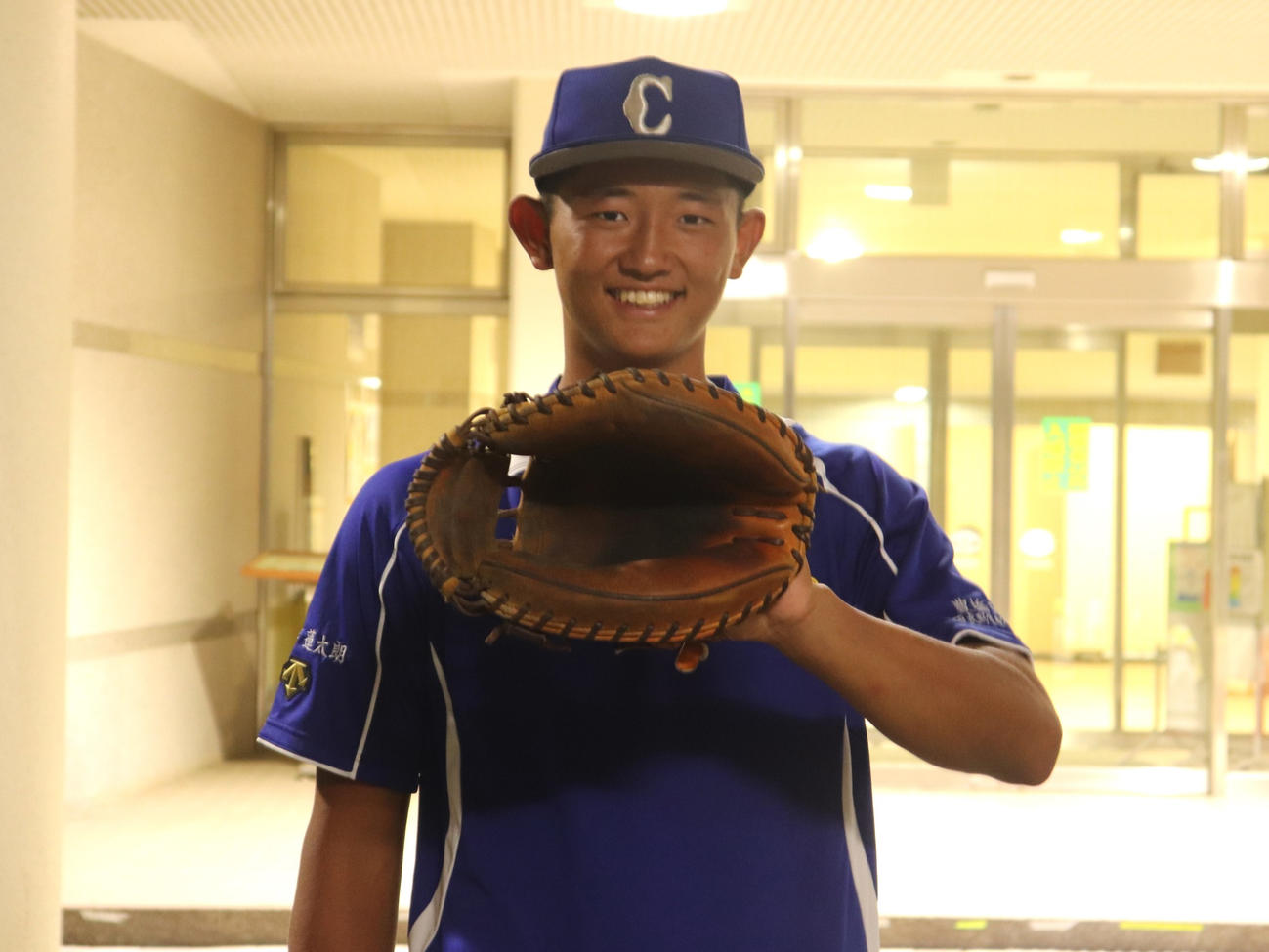 愛知大会準々決勝　享栄対東邦　試合後、ミットを手に笑みを浮かべる豊橋中央の「5番捕手」松井（撮影・中島麗）
