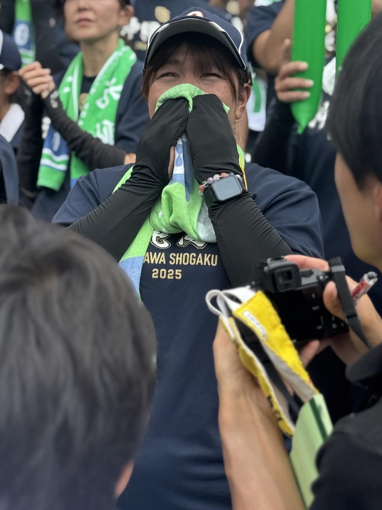 沖縄尚学の主将・真喜志拓斗の優勝インタビューを涙ぐみながら見つめる、この日45歳の誕生日を迎えた母奈津美さん（撮影・中島麗）