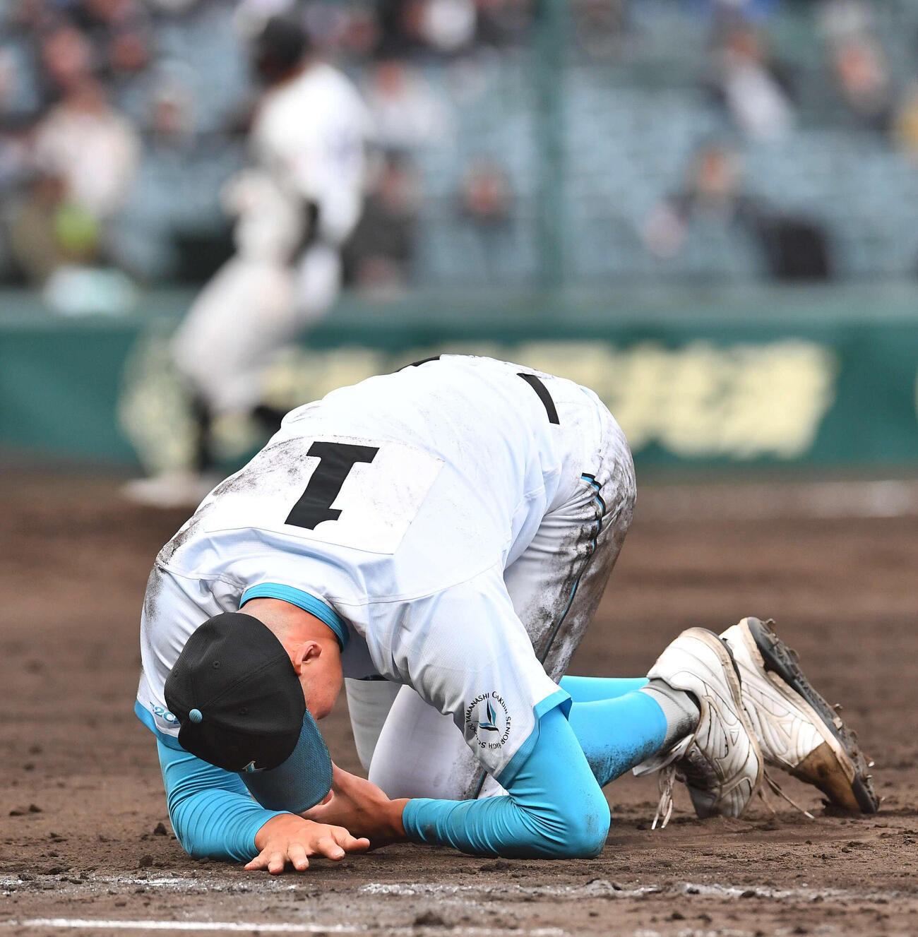 山梨学院対長崎日大　5回裏長崎日大2死一塁、三塁からの悪送球で打者の平野と交錯し左手を痛めた一塁手の山梨学院菰田（撮影・岩下翔太）