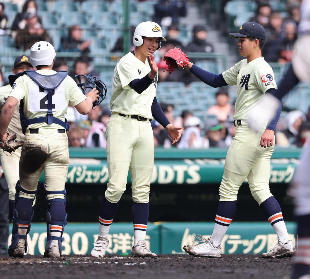 高川学園対英明　完投勝利の英明冨岡（右）はナインとタッチをかわす（撮影・西尾就之）