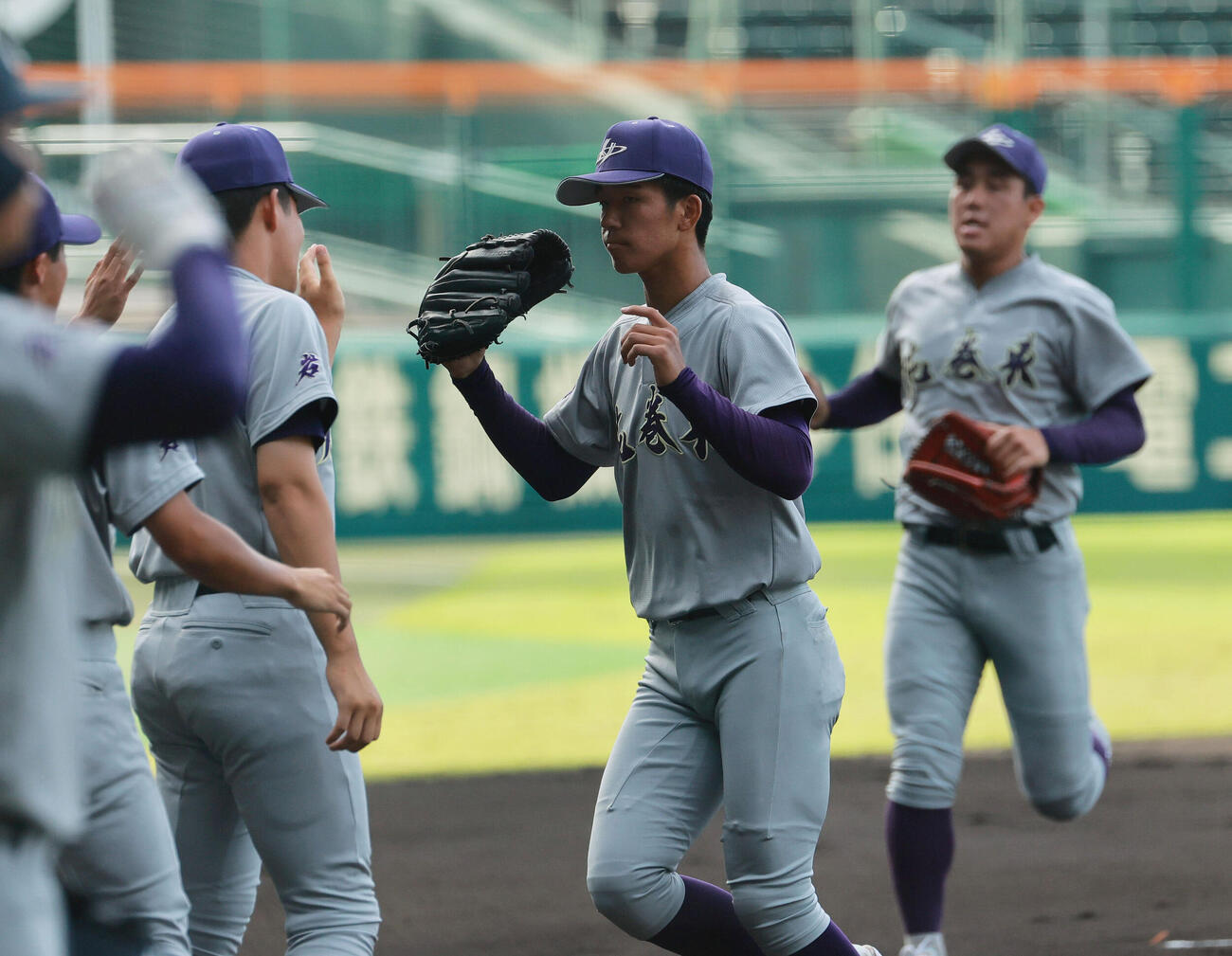 花巻東対新田　花巻東先発の万谷堅心（手前）は初回を無失点で投げ終えベンチに引き揚げる（撮影・上山淳一）