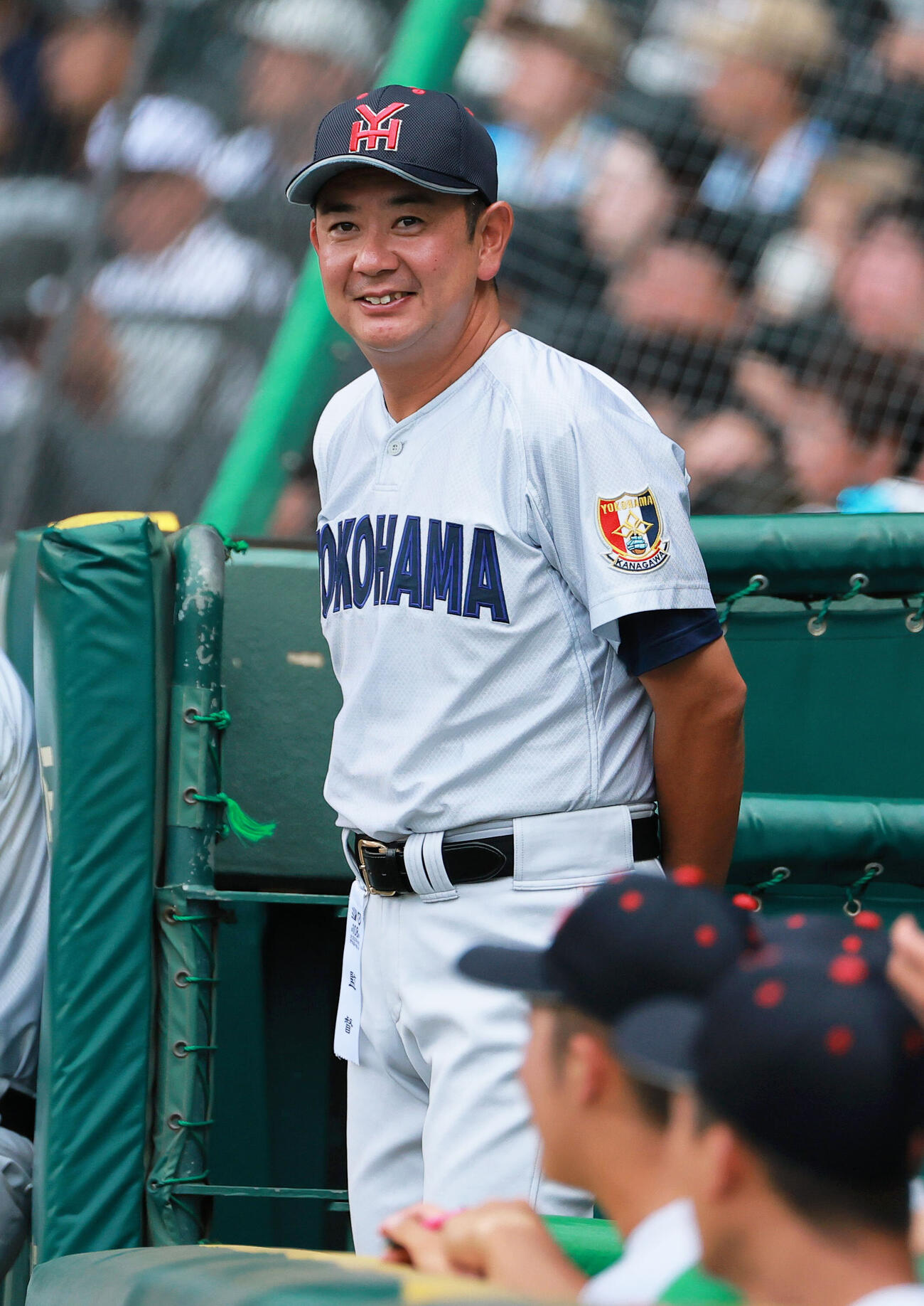 横浜対霞ケ浦　ベンチで笑顔を見せる横浜の村田浩明監督（撮影・上山淳一）