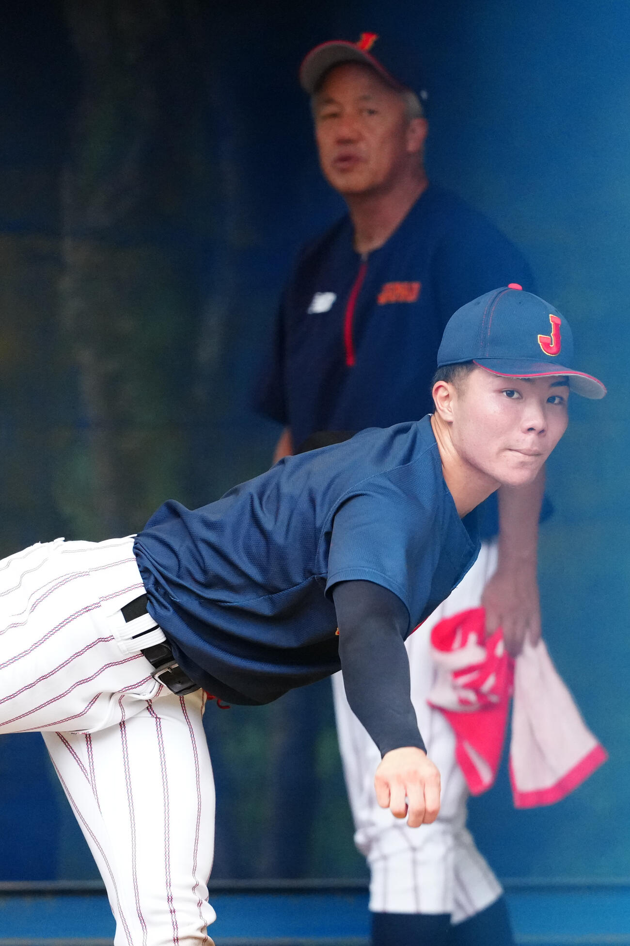 岡田龍生監督（後方）が見つめる中、ブルペン投球する福島陽奈汰（撮影・江口和貴）
