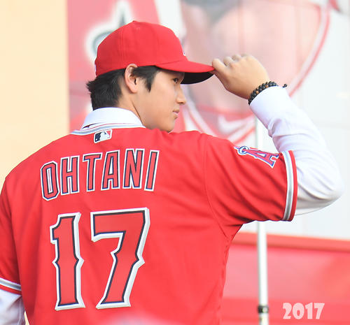 エンゼルス入団会見で背番号17のユニホームに袖を通しポーズをとる大谷翔平＝２０１７年12月９日