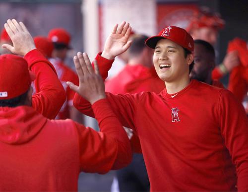 ブルワーズ戦の試合前、チームメートとタッチするエンゼルス大谷（共同）