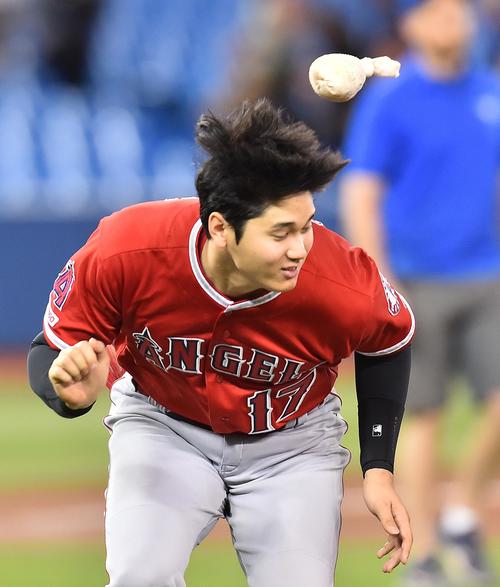 ブルージェイズに勝利し、ナインとハイタッチをするエンゼルス大谷は、飛んできたロージンを慌てて避ける（撮影・菅敏）