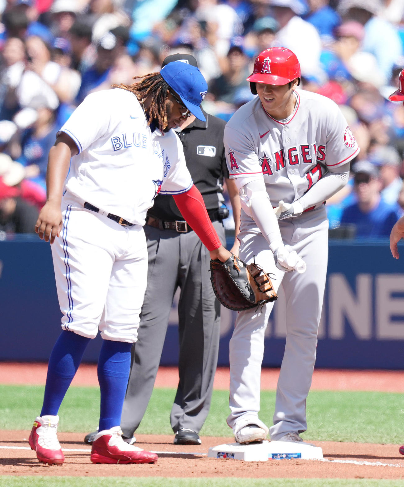 ブルージェイズ対エンゼルス　1回表エンゼルス2死、右前打を放ち、塁上でゲレロ（左）と談笑する大谷（撮影・菅敏）