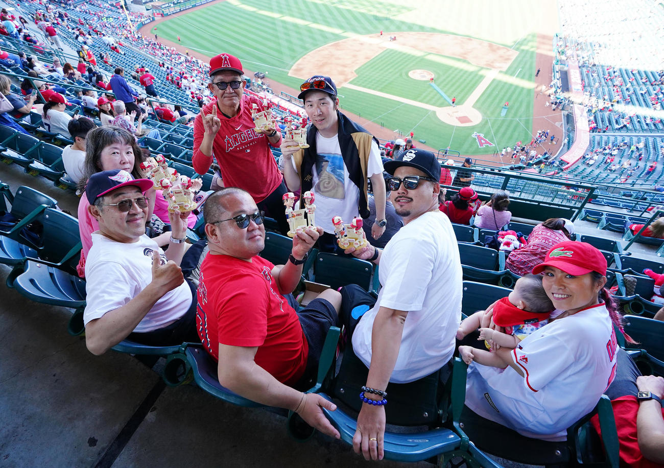 エンゼルス対ダイヤモンドバックス　試合前、先着入場者に配られる大谷とトラウトのボブルヘッドを手に笑顔を見せるエンゼルスファン（撮影・垰建太）