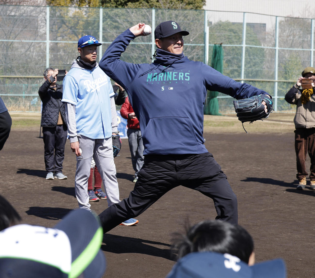 野球教室にゲスト講師として参加しデモンストレーションで投球を披露する岩隈久志氏。左はマック鈴木氏（撮影・中島郁夫）