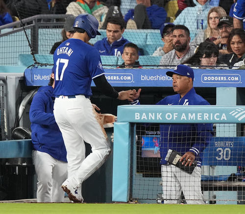 ドジャース対エンゼルス　5回、一塁残塁に終わり、ロバーツ監督（右）にタッチで迎えられる大谷（撮影・菅敏）