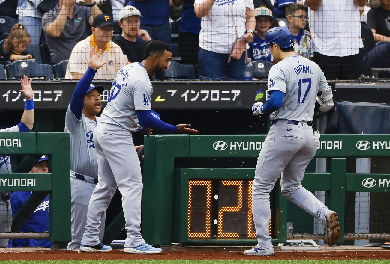 パイレーツ戦の3回、15号2ランを放ち、（左から）ロバーツ監督、T・ヘルナンデスに迎えられるドジャース大谷（共同）