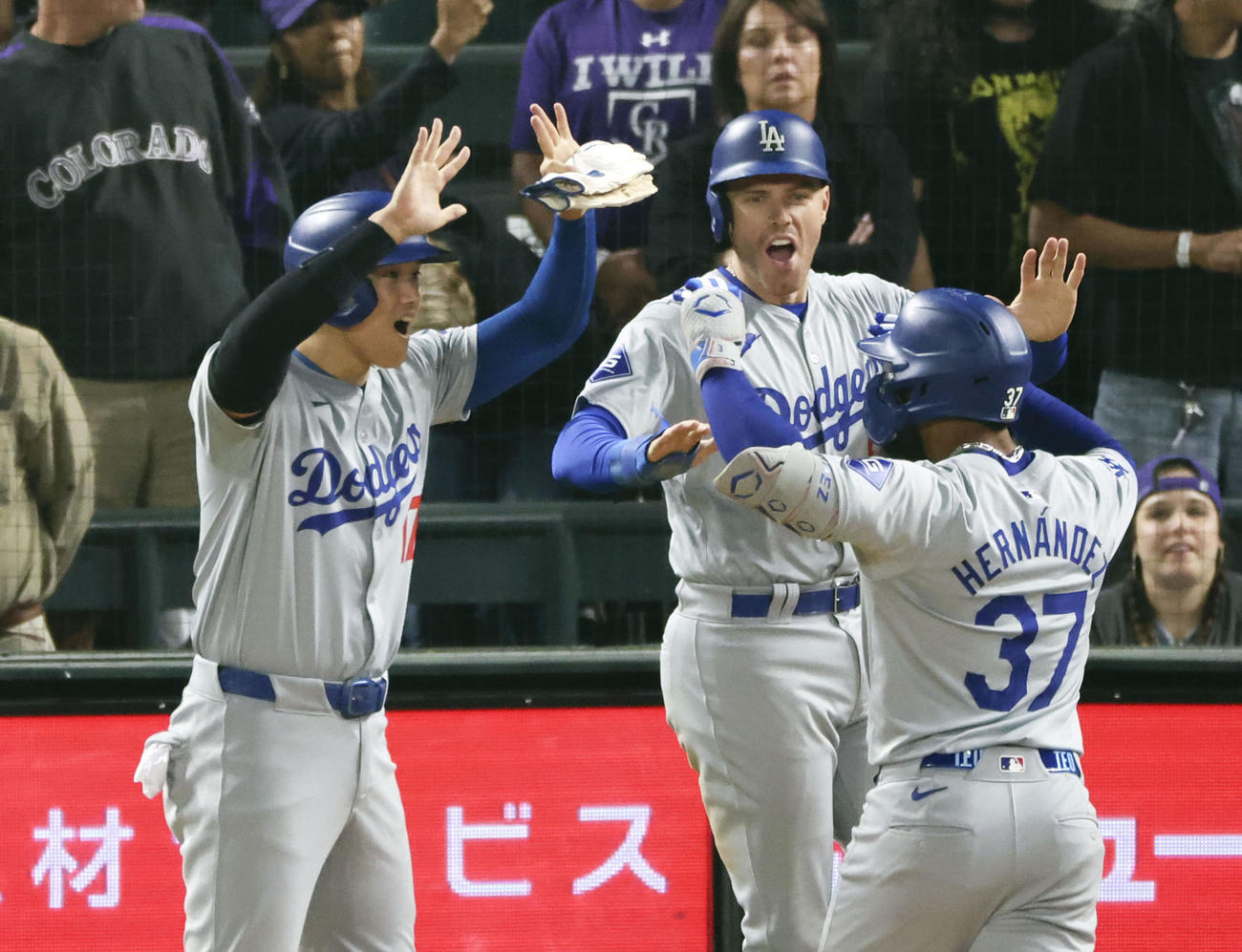 ロッキーズ戦の9回、逆転3ランを放ったT・ヘルナンデス（37）を迎える、生還したドジャース大谷（左）とフリーマン（共同）