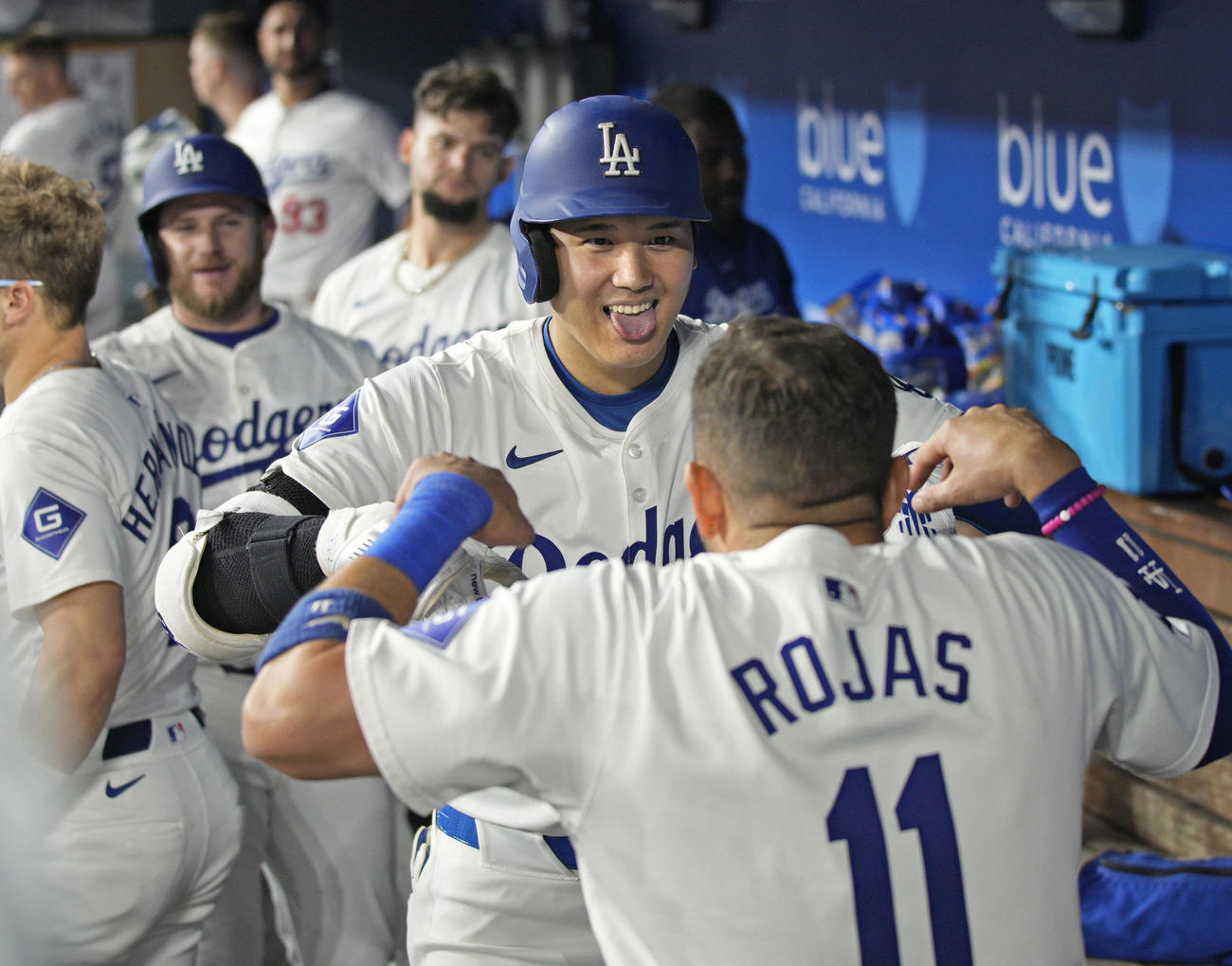 ロッキーズ戦の5回、2試合連続本塁打となる52号2ランを放ち、ロハス（11）に迎えられるドジャース・大谷（共同）