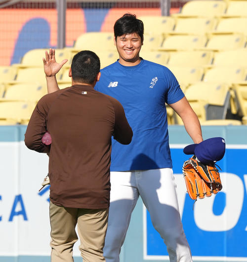ドジャース対パドレス　試合前、パドレス松井（手前）に握手であいさつするドジャース大谷（撮影・菅敏）