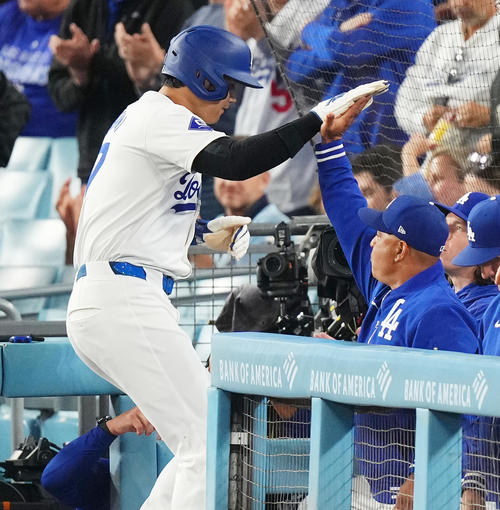 ドジャース対パドレス　1回裏ドジャース2死二塁、T・ヘルナンデスの適時打で二塁から生還し、ロバーツ監督（右）にタッチで迎えられる大谷（撮影・菅敏）