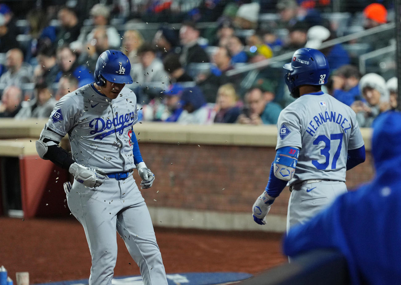 メッツ対ドジャース　1回表ドジャース無死、右越えに先制のソロ本塁打を放ち、T・ヘルナンデス（右）にヒマワリの種で祝福される大谷（撮影・菅敏）